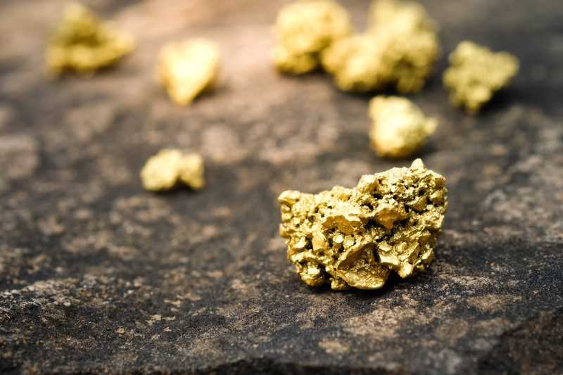 lumps of gold on stone background